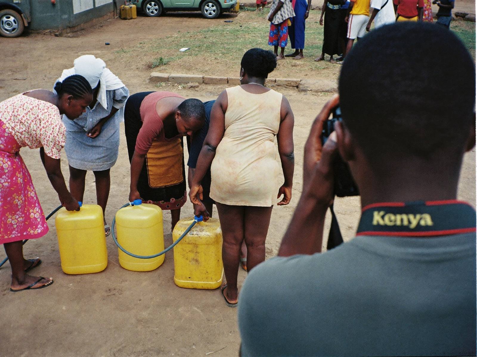 Photographer documenting women at a community water point