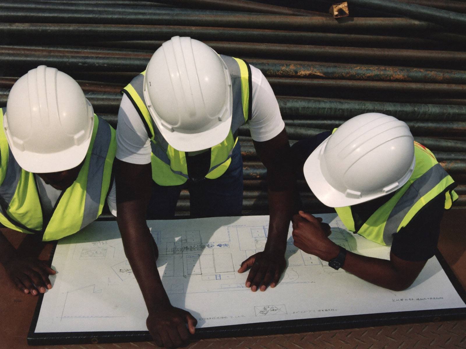 Engineers reviewing technical drawings on site