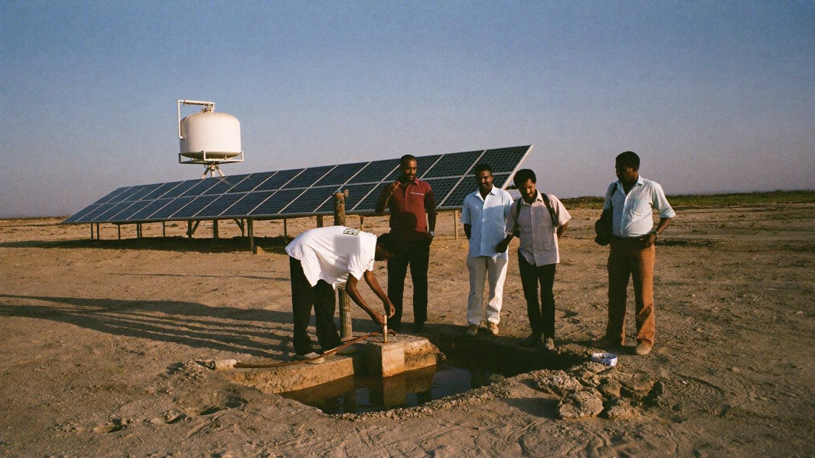 Officials and engineers inspecting a completed solar powered water point